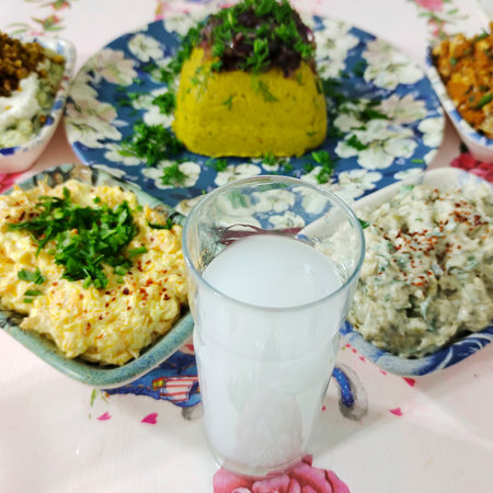 Traditional Turkish and Greek dinner appetizer table with a glass of milkの写真素材