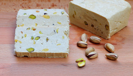 Traditional turkish delight lokum with pistachios on wooden backgroundの写真素材