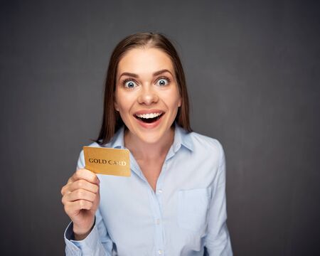 Surprised woman with open mouth holding credit card.