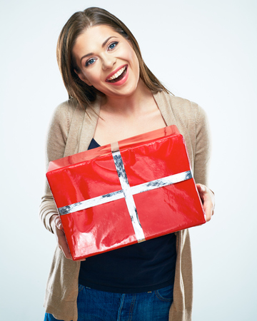 Joyful woman hold red gift box. Isolated portrait.の写真素材