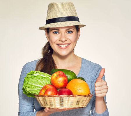 Vegetarian lifestyle portrait of young woman wearing modern hat.の写真素材