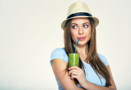 Smiling woman drinking detox drink looking to side.の写真素材