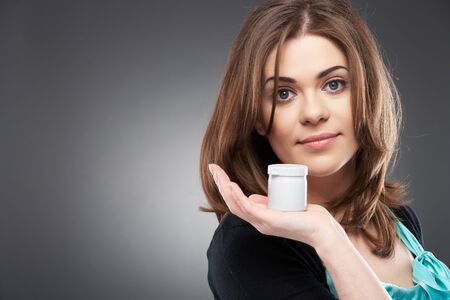 Young smiling woman with cream ( shampoo ), isolated on gray backgroundの写真素材