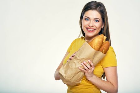 Smiling woman holding bread. Isolated studio portrait.の写真素材