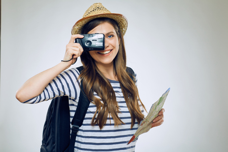 Smiling woman taking pictures with camera. Isolated.の写真素材