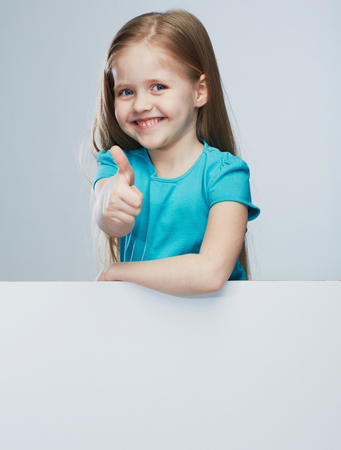 Girl child with white board. Isolated portrait.Thumb up.  Kid.の写真素材