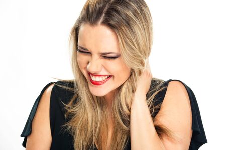 Beautiful laughing woman portraite  on white background with closed eyes, isolated, closeupの写真素材