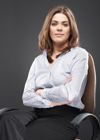 Beautiful business woman portrait sitting in chair. Relaxing female office workerの写真素材