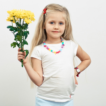 Girl hold yellow flowers. Isolated portrait.の写真素材