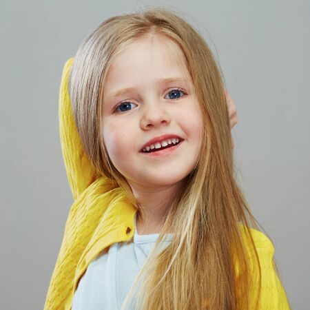 Happy girl child with long blond hair. Isolated portrait.の写真素材