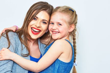 Mother and daughter embrace. Smiling and happy woman with little girl.の写真素材