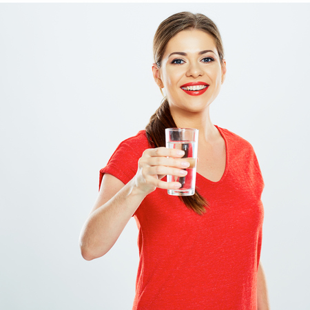 smiling woman hold water glass . studio portrait on white background .の写真素材