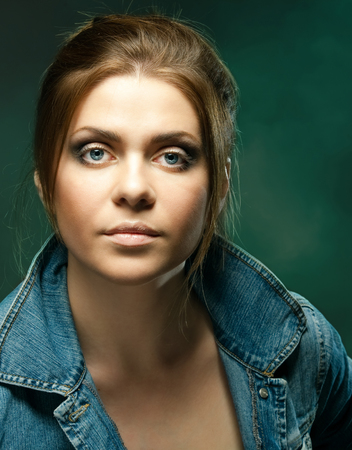 Portrait of a beautiful young sexy woman. Sexy model posing on  dark azure background in studio.の写真素材