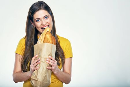 Funny woman face close up portrait, girl bites bread. Isolated on white.