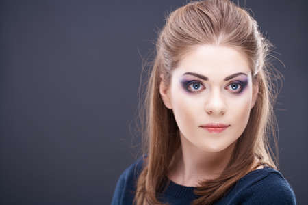 Beautiful young woman face. Close up studio portrait with gray background copy-space.の写真素材