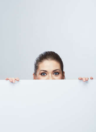 Business woman face looking out white banner. Female modelの写真素材