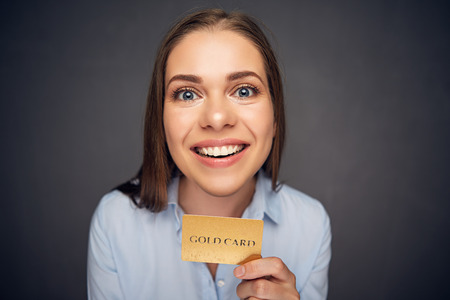 Funny face portrait of business woman holding credit card. Smile with teeth.の写真素材