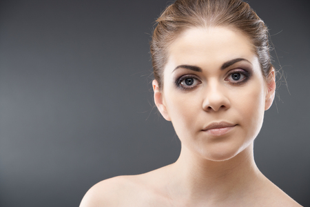Young woman portrait. Closeup beauty studio shoot. Healthy clean skin and perfect makeup on beautiful face of white modelの写真素材