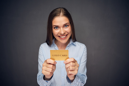 Funny face portrait of business woman holding credit card. Smile with teeth.の写真素材