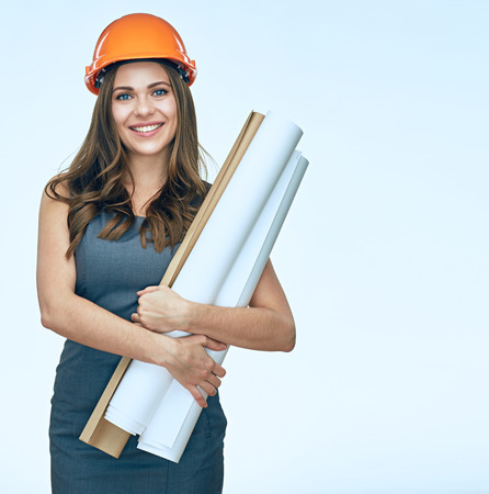 Smiling business woman arcitect isolated portrait. Woman with blueprints.の写真素材