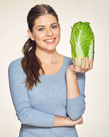 Green diet with healthy food and beautiful smiling woman. Isolated studio portrait .の写真素材