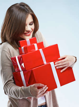 Happy smiling woman hold red gift box. Isolated studio background female model.