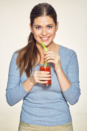smiling woman drink red juice. studio isolated portrait.の写真素材