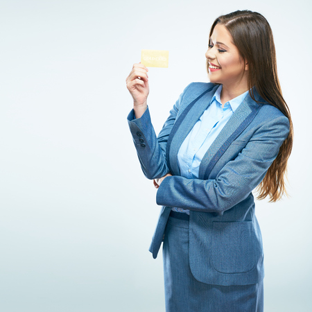 Happy business woman in suit credit card show. White background isolated.の写真素材