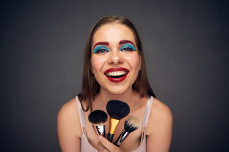 Make up artist with crazy emotion. Isolated portrait.の写真素材