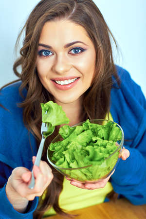 portrait of young woman eating healthy food. vegetarian diet. green food.の写真素材