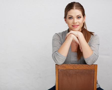 Woman sitting on chair , beautiful model . Chair back . Isolated .の写真素材