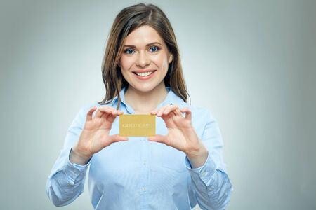 Business woman holding credit card isolated portrait with happy emotion.の写真素材