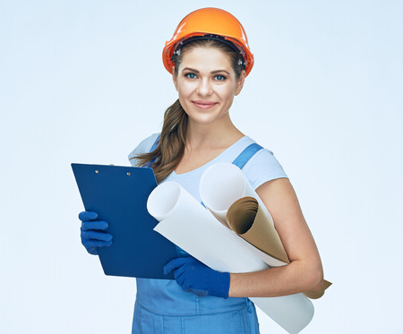 Woman builder holding blueprints, clipboard. Smiling architect girl. Isolated portrait.の写真素材