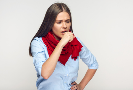 Sickness woman coughing in fist. Portrait of illness girl wearing red scarf.の写真素材