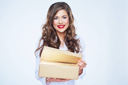 Young woman isolated portrait with open box. Smiling female model with long curly hair.の写真素材