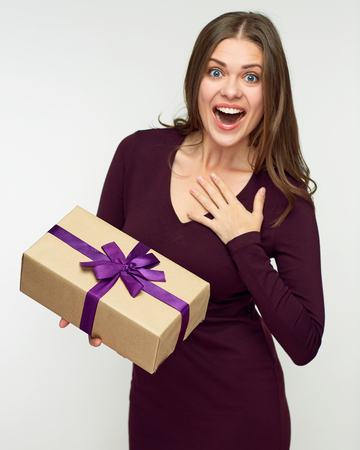 Happy woman holding paper gift box. Isolated portrait.の写真素材