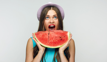 Watermelon and beautiful smiling girl with red lips. Isolated portrait.の写真素材