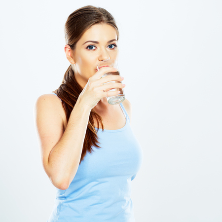 woman drinking water with glass . isolated portrait on white background .の写真素材