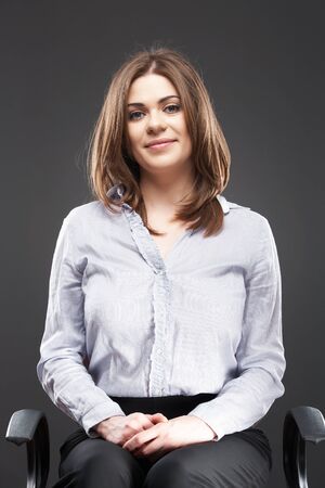 Beautiful business woman [ bank employee ] portrait sitting in chair. Relaxing female office workerの写真素材