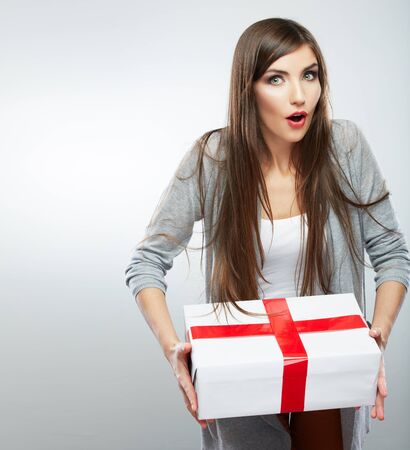 Young woman portrait hold gift in christmas color style . Smiling happy girl on white background.の写真素材
