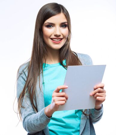 Teenager girl hold white blank paper. Young smiling woman show blank card. Girl portrait isolated on white background.の写真素材