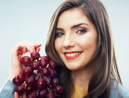 Woman diet concept portrait with red grape fruitの写真素材