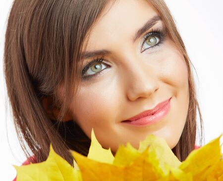 Yellow autumn leaves, close up woman face portraitの写真素材