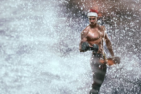 Holidays and celebrations, New year, Christmas, sports, bodybuilding, healthy lifestyle - Muscular handsome sexy Santa Clausの写真素材