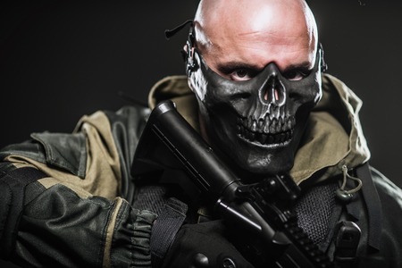 Military, war, conflict, soldiers - a military man in a black mask on a dark background.