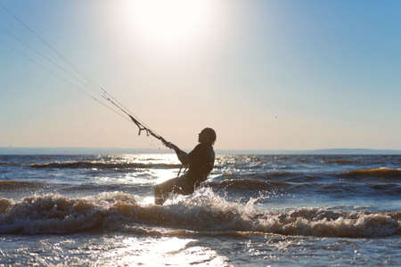 Kiteboarding. A kite surfer rides the waves. A middle-aged man enjoys riding the waves on a kite. A...