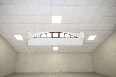 An empty bright room. Three walls, ceiling, floor and window.