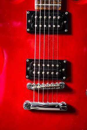 Red electric guitar, The six strings of the electric guitar are taken in close-up.