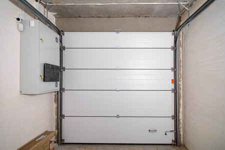 Garage in a newly built residential building. Garage lift door. Video surveillance system.の写真素材