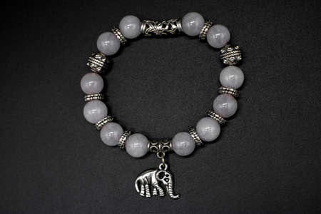Hand bracelet with pearls and an elephant figurine isolatedの写真素材